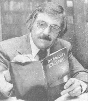 A grainy, black and white portrait of Jim Metcalf from 1974. He is seated at a desk, though very little of it is in frame. He wears lightly tinted, aviator frame reading glasses, and his greying black hair is looser and more care-free than his swept back style from the TV studio. He is silently reading from his first published work of poety, 'Jim Metcalf's Journal' with the front and back covers facing toward the camera. The front cover shows a warmly lit sunset from the south shore of Lake Ponchartrain in New Orleans. The shoreline, along with a lone figure on the shore and a sailboat in the distance, is darkened by the vivid exposure of the sun, leaving only a suggestion of the foreground.